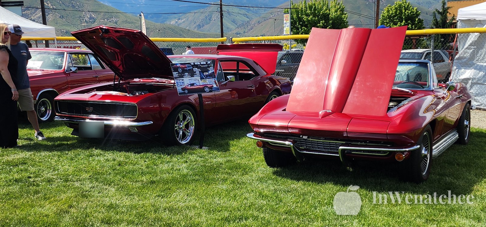 A red classic Camaro and Corvette with hoods up at the East Wenatchee car show during Apple Blossom 2026